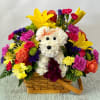 Arrangement of fresh cut flowers designed in a brown rectangular basket. Includes