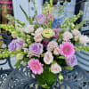 Pops of pastel blooms designed to a medium height loaded with roses
