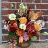A beautiful fall arrangement in a copper vase for any special occasion.