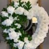 This white rose and Mums arrangement is a beautiful addition to your