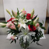a glass vase bouquet available year round, with lilies, roses and delicate