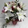 a glass vase bouquet available year round, with lilies, roses and delicate