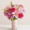 All-around arrangement with hot-pink roses; pink snapdragons, Asiatic lilies, and Peruvian lilies