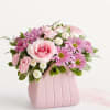 Arrangement of pink roses and mini carnations, white button poms, lavender daisy
