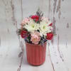 A cute, petite floral arrangement on top of a 12 oz. Swan