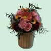 A cute, petite floral arrangement on top of a 12 oz. Swan