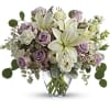  Lavender roses, creamy white lilies and delicate greens create a soft
