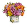 A lively mix of lavender roses, orange alstroemeria, yellow daisies, and purple