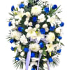 Soft whispers of remembrance are carried through this beautiful standing spray. Delicately