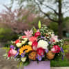 A charming floral bag filled with gerberas delicate roses, and a bright