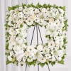 tanding spray arrangement features a stylized 18&quot; square wreath with white roses