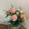 Pastel flowers make this arrangement perfect for those moments in life that