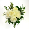 A timeless petite prom bouquet, featuring pristine white roses surrounded by lush