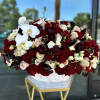  A Stunning vase arrangement filled with premium flowers in burgundy colors