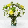 With yellow roses, white daisies and green button poms, the Happy Day