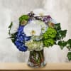 This unique design includes several shades of hydrangea, white phalaenopsis orchids, scabiosa