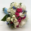A mix of mostly white flowers with pops of hot pink and
