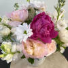A special vase with ceramic birds lining the rim. There is a