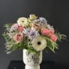 This is a beautiful pastel arrangement in a beautiful container. 