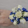1 corsage, with white roses (or another color) baby breath, green leaves