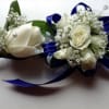 Corsage and boutonni&egrave;re with white roses, baby breath, and blue ribbon 
Ramillete
