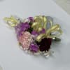 Pink, purple and red corsage with gold ribon.