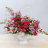 Sprawling snapdragons give this arrangement a touch of drama while the hot