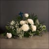 Traditional funeral arrangement with a stained glass cross. The color of the