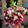 Bold. Romantic. Unforgettable. This vibrant clay vase arrangement bursts with fuchsia and