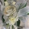 A classic white corsage with silver or gold sheer ribbon. This wrist