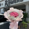 A wrapped bouquet of flowers is a beautifully arranged collection of blooms