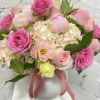 Beautiful and bright flower arrangement with peonies, ranunculus, Lisianthus, hydrangeas and roses.