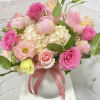Beautiful and bright flower arrangement with peonies, ranunculus, Lisianthus, hydrangeas and roses.
