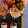 Two bottles of Potter&rsquo;s grapefruit hibiscus cider nest on a bed of