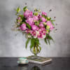 Behold the exquisite beauty of our Floral Fusion arrangement, delicately showcased within
