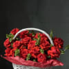 basket of red roses with greenery