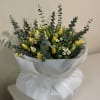 large bouquet of yellow tulips with small daisies