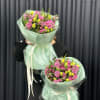bouquet with purple tulips in green packaging