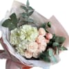 Delicate compliment bouquet of hydrangea and bush rose with eucalyptus greenery.

