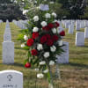 This striking spray with its red roses and white carnations is a