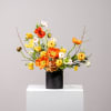 This vibrant floral arrangement bursts with colors. Bright orange and yellow poppies