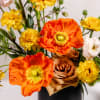 This vibrant floral arrangement bursts with colors. Bright orange and yellow poppies