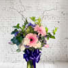 An elegant and thoughtfully designed arrangement featuring soft pink gerberas, blush carnations