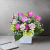 This bold and joyful arrangement features a striking mix of pink garden