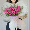 This graceful butterfly-shaped bouquet features 24 enchanting purple roses, beautifully accented with