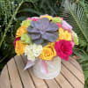 Mixed flower arrangement in a hat box.