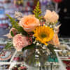 short glass vase arragement. Hypericum is used as shown on the deluxe