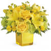 An instant pick-me-up! Beautifully arranged in a stylish cube vase, these radiant