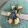 A blue corsage with a touch of white and pink. This can