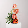 This captivating floral arrangement showcases anthurium flowers rising from a sleek black